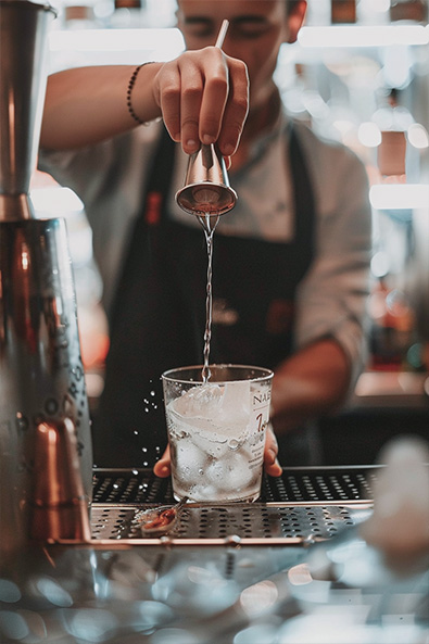 raw image bartender mixing cocktail