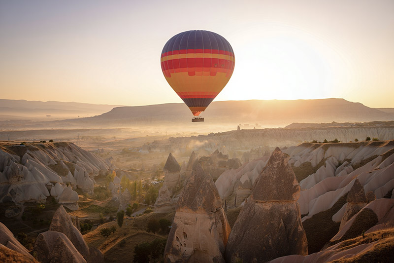 Before hot air balloon above the distinctive rock formations of Cappadocia, Turkey