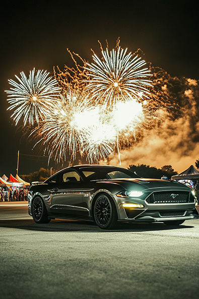 After Ford Mustang GT parked near a carnival, a massive fireworks display exploding in the sky