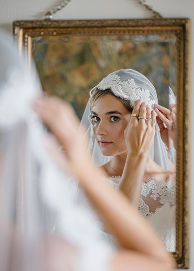 Before close-up photograph shows a bride's hands wearing multiple rings