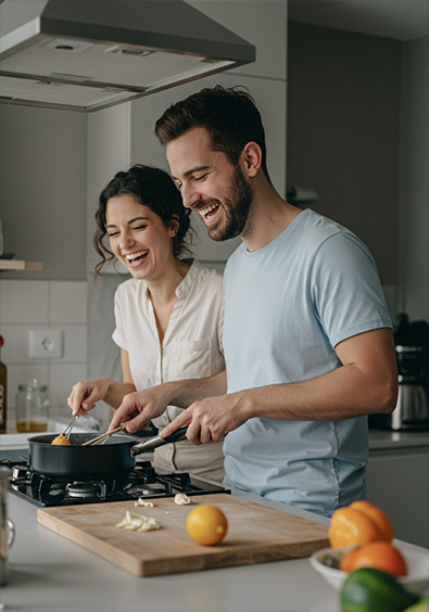 Before couple in their thirties, cooking together in a modern kitchen