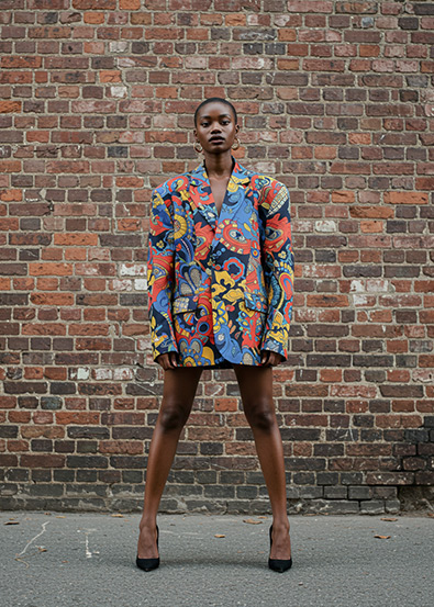 Before fashion model posing in front of a weathered brick wall,