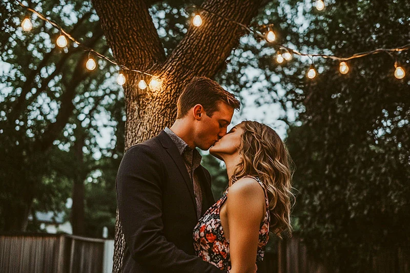 Image with preset applied -couple kissing under a tree at twilight